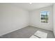 Empty bedroom with soft carpet, white walls, and a window at 3727 Rosebush Dr, Zebulon, NC 27597