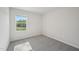 Bright bedroom with a window overlooking the outdoor landscape and neutral carpet at 3727 Rosebush Dr, Zebulon, NC 27597