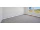 Bright bedroom featuring two windows, neutral walls, white trim, and plush carpeting at 3727 Rosebush Dr, Zebulon, NC 27597