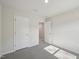 Cozy bedroom with carpet, white walls, and a doorway to another room at 3727 Rosebush Dr, Zebulon, NC 27597