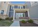 Charming two-story townhome with blue siding, brick accents and inviting front porch at 3727 Rosebush Dr, Zebulon, NC 27597