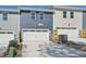 Exterior view of attached garages with two-car capacity, showing blue and gray siding at 3727 Rosebush Dr, Zebulon, NC 27597
