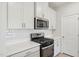 Well-lit kitchen features white cabinets, stainless steel appliances, and a subway tile backsplash at 3727 Rosebush Dr, Zebulon, NC 27597