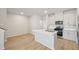 Bright kitchen featuring island with sink, stainless steel appliances, and white cabinets at 3727 Rosebush Dr, Zebulon, NC 27597