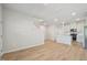 Open-concept living space with hardwood floors, stairs, and a modern kitchen at 3727 Rosebush Dr, Zebulon, NC 27597