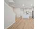 Open-concept living space with hardwood floors, stairs, and a modern kitchen at 3727 Rosebush Dr, Zebulon, NC 27597