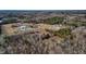 A bird's eye view of the property showing the buildings, landscaping, and the surrounding natural environment at 3817 Nc-119, Mebane, NC 27302