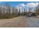 Spacious backyard with a covered parking area and lush greenery offering a private and serene setting at 3817 Nc-119, Mebane, NC 27302