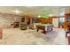 Basement featuring stone accent wall, billiards table, built-in shelving, and a comfortable seating area at 3817 Nc-119, Mebane, NC 27302