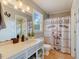 Charming bathroom with decorative mirror, farmhouse-themed shower curtain, and sink at 3817 Nc-119, Mebane, NC 27302