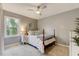 Comfortable bedroom with a window, a ceiling fan, carpet, and a wood-framed bed at 3817 Nc-119, Mebane, NC 27302