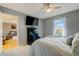 Relaxing bedroom with ceiling fan, carpet, dresser, and view to the outside at 3817 Nc-119, Mebane, NC 27302