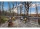 Inviting wooden deck featuring cozy seating arrangements and serene, tree-lined backdrop at 3817 Nc-119, Mebane, NC 27302