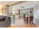 Charming dining area with tile floors adjacent to the open kitchen with white cabinets at 3817 Nc-119, Mebane, NC 27302