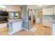 Open kitchen featuring stainless steel refrigerator, tile floors, and view of living room at 3817 Nc-119, Mebane, NC 27302
