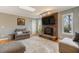 Comfortable living room featuring a brick fireplace, skylight, and stylish gray furniture at 3817 Nc-119, Mebane, NC 27302