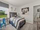 Cozy bedroom featuring a comfortable bed, a desk by the window, and baseball-themed decor at 3817 Rosebush Dr, Zebulon, NC 27597