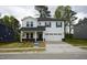 Charming two-story home with a white exterior, black shutters, and a well-manicured lawn at 3817 Rosebush Dr, Zebulon, NC 27597