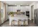 Modern kitchen featuring white cabinets, stainless steel appliances, and a large center island with seating at 3817 Rosebush Dr, Zebulon, NC 27597