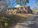 Inviting brick house with green accents and a charming front yard on a slightly sloping lot at 402 Willow St, Cary, NC 27511