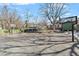 The backyard features a full basketball court and is surrounded by mature trees at 410 N Lamar St, Roxboro, NC 27573