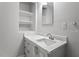 A well-lit bathroom featuring modern vanity, a sink, a mirror, and recessed lighting at 410 N Lamar St, Roxboro, NC 27573