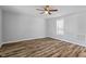 Cozy bedroom featuring a ceiling fan, neutral paint and gleaming wood floors at 410 N Lamar St, Roxboro, NC 27573