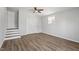 This bedroom features wood-look flooring, a ceiling fan, and access to upper level at 410 N Lamar St, Roxboro, NC 27573