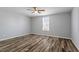 Bright bedroom offers a ceiling fan, natural light from large window, and luxury vinyl plank flooring at 410 N Lamar St, Roxboro, NC 27573