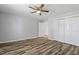 Bedroom featuring luxury vinyl plank flooring, a ceiling fan, closet, and an entrance to another room at 410 N Lamar St, Roxboro, NC 27573