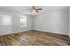 Bright bedroom featuring a ceiling fan and gleaming wood floors at 410 N Lamar St, Roxboro, NC 27573