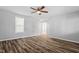 Neutral paint, ceiling fan, and luxury vinyl plank flooring complete this bedroom at 410 N Lamar St, Roxboro, NC 27573
