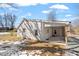 Back exterior view of white painted brick home with a covered porch and some snow at 410 N Lamar St, Roxboro, NC 27573