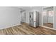 An open-concept kitchen featuring stainless steel refrigerator, and wood-look vinyl flooring at 410 N Lamar St, Roxboro, NC 27573