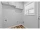 The laundry room is spacious with white cabinets and a window for natural light at 410 N Lamar St, Roxboro, NC 27573