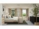 Comfortable main bedroom featuring a decorative ladder, a plush armchair, and abundant natural light at 4120 Shadbush St, Raleigh, NC 27616