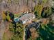 Aerial view of a luxurious home with a sparkling pool and mature trees, providing privacy and elegance at 4708 Wynneford Way, Raleigh, NC 27614