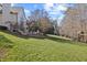 Expansive backyard with lush lawn, landscaped terrace, and playset for outdoor enjoyment at 4708 Wynneford Way, Raleigh, NC 27614