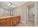 Bathroom vanity with a large mirror and tile flooring at 4708 Wynneford Way, Raleigh, NC 27614