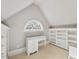 Neutral bedroom with a built-in desk and shelving, with a large window to outside at 4708 Wynneford Way, Raleigh, NC 27614