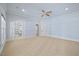 Spacious carpeted bedroom featuring a ceiling fan and natural light at 4708 Wynneford Way, Raleigh, NC 27614