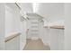 Walk-in closet featuring custom shelving and wooden rods for ample storage space at 4708 Wynneford Way, Raleigh, NC 27614