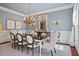 Formal dining room with wainscoting, chandelier, and ample seating at 4708 Wynneford Way, Raleigh, NC 27614