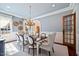 Elegant dining room with a chandelier, large window, and classic decor at 4708 Wynneford Way, Raleigh, NC 27614