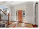 Welcoming foyer with a hardwood floors, staircase, arched entry and bright front door at 4708 Wynneford Way, Raleigh, NC 27614