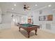 Entertainment area with a full-size billiard table, ceiling fan, and carpeted flooring at 4708 Wynneford Way, Raleigh, NC 27614