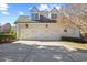 Three-car garage with white doors and ample driveway space on a sunny day at 4708 Wynneford Way, Raleigh, NC 27614