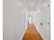 Hallway with hardwood floors and neutral paint, leading to various rooms at 4708 Wynneford Way, Raleigh, NC 27614