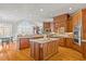 Spacious kitchen with custom wood cabinets, large island, and stainless steel appliances at 4708 Wynneford Way, Raleigh, NC 27614