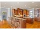 Gourmet kitchen featuring wood cabinets, granite countertops, stainless steel appliances, and a large island with bar seating at 4708 Wynneford Way, Raleigh, NC 27614